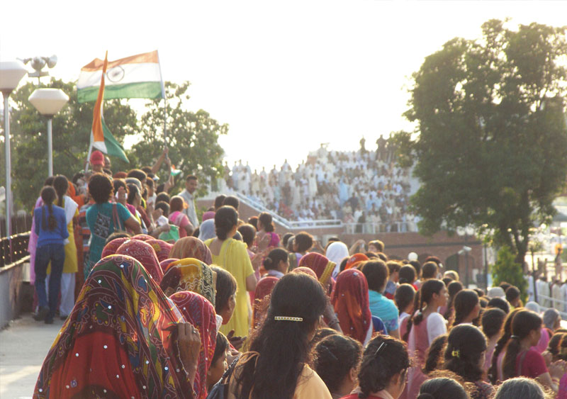 Children, men and women gather at both the sides of the countries at Wagah Border