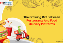 The Growing Rift Between Restaurants and Food Delivery Platforms in India Illustration showing a growing conflict between restaurants and food delivery platforms. The image features a burger, fries, and a soft drink emerging from a mobile screen on the left, and a food delivery rider on a red scooter on the right.