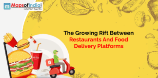 The Growing Rift Between Restaurants and Food Delivery Platforms in India Illustration showing a growing conflict between restaurants and food delivery platforms. The image features a burger, fries, and a soft drink emerging from a mobile screen on the left, and a food delivery rider on a red scooter on the right.