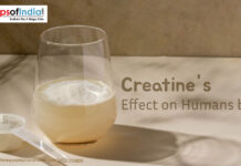 Creatine’s Effect on Human Body A glass of creatine mixed with water placed on a light surface beside a scoop of creatine powder.