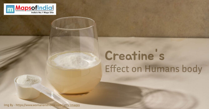A glass of creatine mixed with water placed on a light surface beside a scoop of creatine powder.