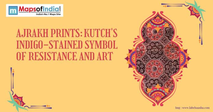 Illustrative banner featuring traditional Ajrakh print patterns with the title “Ajrakh Prints: Kutch’s Indigo-Stained Symbol of Resistance and Art,” highlighting the cultural heritage of Gujarat’s block-printing craft.