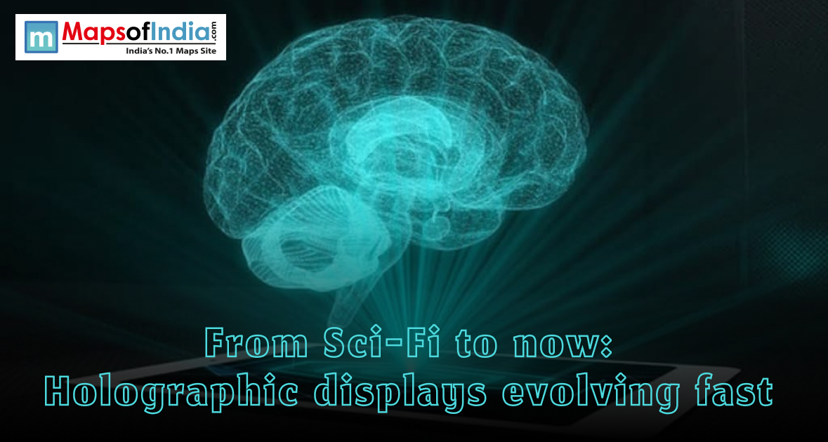 A glowing blue 3D holographic brain projection emerging from a flat surface, with the headline "From Sci-Fi to now: Holographic displays evolving fast"