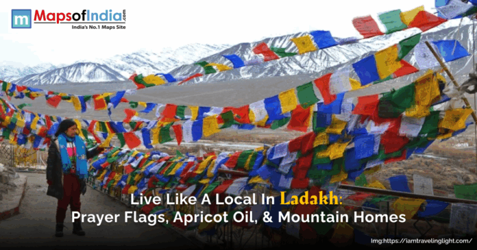 A view of Ladakh valley with several colourful flags. The beauty of mountains covered with snow.