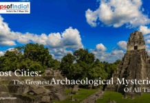 Lost Cities: The Greatest Archaeological Mysteries of All Time Ancient Mayan ruins surrounded by lush green forest under a bright blue sky with white clouds, representing lost cities and great archaeological mysteries.