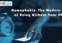 Nomophobia: The Modern Fear of Being Without Your Phone Person anxiously looking at their smartphone, illustrating nomophobia—the fear of being without a phone.