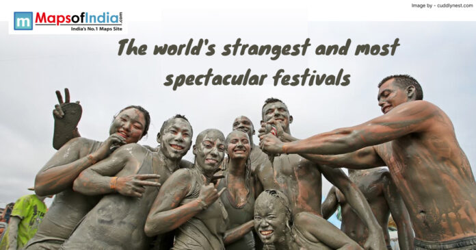 Group of people covered in mud enjoying a unique cultural celebration during one of the world’s strangest and most spectacular festivals