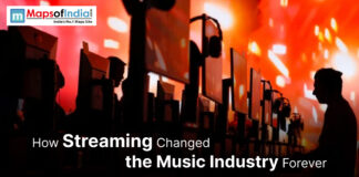 How Streaming Changed the Music Industry Forever Rows of people using desktop computers with large monitors and headphones, set against a vibrant orange and red background, illustrating the concept of streaming’s impact on the music industry.