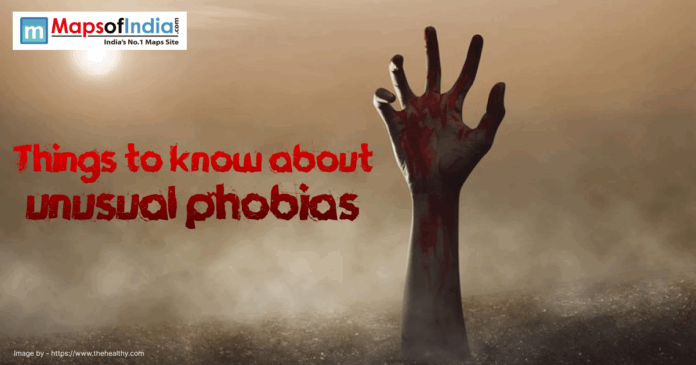 A dark and eerie image of a bloodied hand reaching out from the ground with fog.