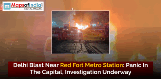 Delhi Blast Near Red Fort Metro Station: Panic in the Capital, Investigation Underway Delhi Police barricades and emergency vehicles block a street at night as flames and smoke rise from a blast near the Red Fort Metro Station in Delhi.