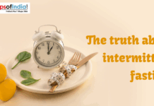 The Truth About Intermittent Fasting An image showing a clock placed on a plate with a fork, knife, and measuring tape, symbolizing intermittent fasting.