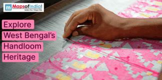 Explore West Bengal’s Handloom Heritage A close-up of a hand weaving a colorful pink and yellow handloom textile, promoting West Bengal’s handloom heritage.