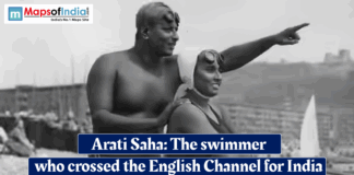 Arati Saha: The Swimmer Who Crossed the English Channel for India Historic black‑and‑white photo of Indian swimmer Arati Saha in a swimsuit on a beach, guided by a man pointing toward the sea, with overlaid text reading “Arati Saha: The swimmer who crossed the English Channel for India.”