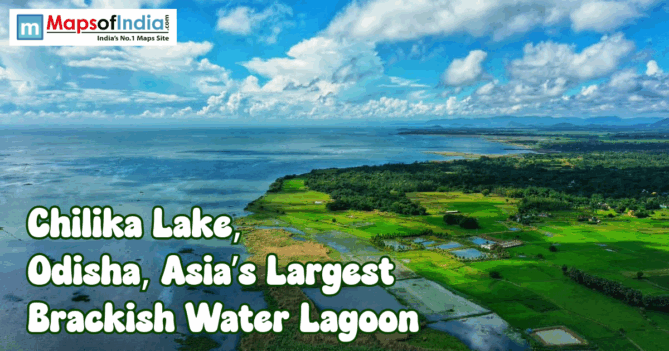 Aerial view of Chilika Lake in Odisha, India, with green fields meeting the blue brackish water lagoon under a bright, cloudy sky and Maps of India logo and title text overlay.