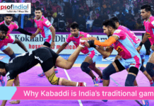 Why Kabaddi is India’s Traditional Game An action shot of a professional Kabaddi match with players in pink and blue jerseys tackling an opponent, titled "Why Kabaddi is India's traditional game".