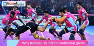 Why Kabaddi is India’s Traditional Game An action shot of a professional Kabaddi match with players in pink and blue jerseys tackling an opponent, titled "Why Kabaddi is India's traditional game".