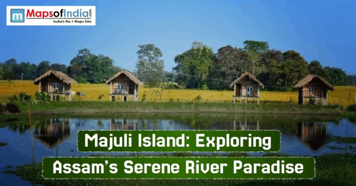 Majuli Island Scenic view of Majuli Island in Assam featuring traditional wooden huts on stilts beside a calm water body, surrounded by lush green fields and trees under a clear blue sky.