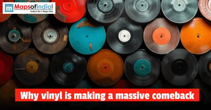 Top view of colorful vinyl records stacked together, illustrating why vinyl is making a massive comeback among music lovers and collectors.