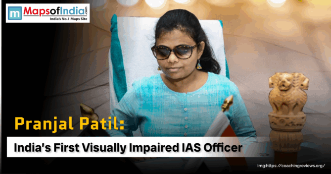 Pranjal Patil, India's first visually impaired IAS officer, sits at her desk with a small Indian flag and the Ashoka Pillar emblem.