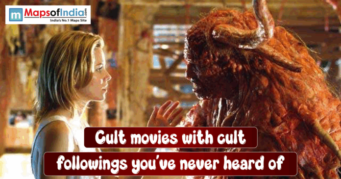 cult movies A woman stands face-to-face with a large, monstrous creature inside a dim, cluttered room. She reaches her hand toward the creature as they appear to confront or communicate with each other.