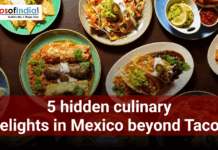 5 hidden culinary delights in Mexico beyond Tacos Overhead view of assorted Mexican dishes on a table, including enchiladas, tacos, rice, guacamole, and salsa, with text reading “5 hidden culinary delights in Mexico beyond Tacos.”
