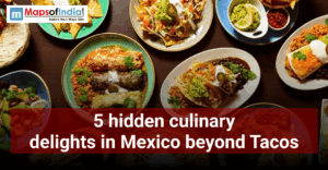 Overhead view of assorted Mexican dishes on a table, including enchiladas, tacos, rice, guacamole, and salsa, with text reading “5 hidden culinary delights in Mexico beyond Tacos.”