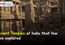 Ancient Temples of India that few have explored A massive, detailed ancient Indian temple carved directly into rock, featuring various chambers and statues, with the text "Ancient Temples of India that few have explored".