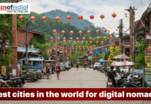 Best Cities in the World for Digital Nomads A vibrant street in a tropical town decorated with hanging red lanterns, featuring a banner that reads, "Best cities in the world for digital nomads."