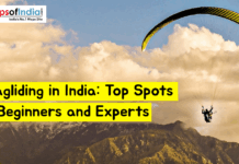 Paragliding in India: Top Spots for Beginners and Experts Paraglider flying over mountain landscape in India with text “Paragliding in India: Top Spots for Beginners and Experts” and Maps of India logo in the corner
