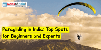 Paragliding in India: Top Spots for Beginners and Experts Paraglider flying over mountain landscape in India with text “Paragliding in India: Top Spots for Beginners and Experts” and Maps of India logo in the corner