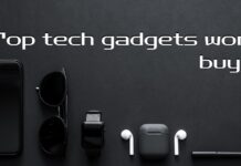 Top Tech Gadgets Worth Buying A flat lay image on a black background featuring a smartphone, sunglasses, a smartwatch, wireless earbuds, and a stylus pen. The text overlay reads "Top tech gadgets worth buying" with a "MapsofIndia" logo in the top left corner.