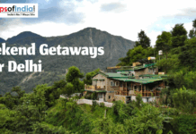 Weekend Getaways Near Delhi Scenic mountain landscape with a stone cottage, green hills, and 'Weekend Getaways near Delhi' text. Maps of India logo visible.
