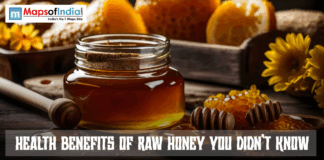 Health Benefits Of Raw Honey You Didn’t Know Jar of raw honey with a wooden dipper and honeycomb on a rustic table, with sunflowers in the background and the text “Health Benefits of Raw Honey You Didn’t Know” displayed.