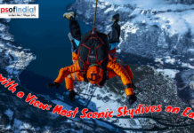 Jump with a View: Most Scenic Skydives on Earth Skydiver in an orange suit descending over a snowy mountain landscape and blue lake, with text overlay about the most scenic skydives on Earth.