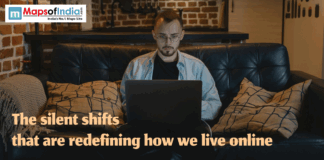 The silent shifts that are redefining how we live online A young man using a laptop while sitting on a couch, symbolizing the silent digital shifts redefining how people live and interact online.
