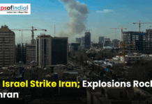 US, Israel Strike Iran; Explosions Rock Tehran Smoke rising over Tehran’s skyline with high-rise buildings and construction cranes, overlaid with the headline “US, Israel Strike Iran, Explosions Rock Tehran” and a Maps of India logo