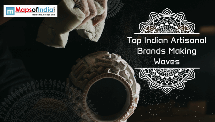 A close-up of an artisan dusting a handcrafted clay pot, with decorative mandala designs and the text “Top Indian Artisanal Brands Making Waves” displayed on a dark background alongside the Maps of India logo