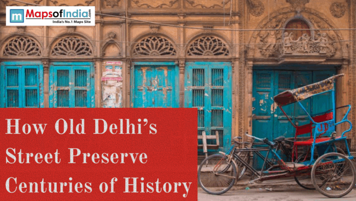 old delhi Old Delhi street with carved heritage facade, blue doors, and a cycle rickshaw parked outside.