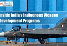 Inside India’s Indigenous Weapon Development Programs Indian Tejas fighter jet displayed in front of a blue hangar with the title “Inside India’s Indigenous Weapon Development Programs.”