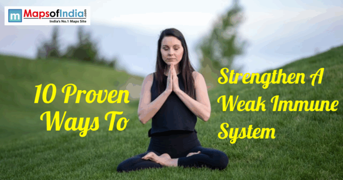 A woman meditating outdoors on grass for immune system health.