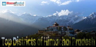 Top Districts of Himachal Pradesh Scenic view of Himachal Pradesh with monastery and snow-capped mountains under blue sky