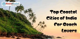 Top Coastal Cities of India For Beach Lovers Tropical beach with palm trees and rocky shore at sunset featuring text “Top Coastal Cities of India for Beach Lovers”