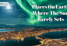 Places On Earth Where The Sun Barely Sets Aerial view of a coastal city under the Northern Lights with text: "Places On Earth Where The Sun Barely Sets."