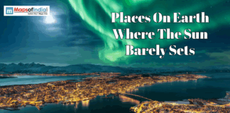 Places On Earth Where The Sun Barely Sets Aerial view of a coastal city under the Northern Lights with text: "Places On Earth Where The Sun Barely Sets."