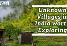 Unknown Villages in India worth Exploring Scenic view of a peaceful village in the Indian hills with forests, greenery, and misty surroundings.