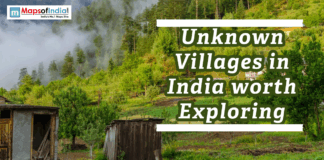 Unknown Villages in India worth Exploring Scenic view of a peaceful village in the Indian hills with forests, greenery, and misty surroundings.