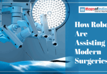 How Robots Are Assisting Modern Surgeries Robotic surgical arms hovering over a patient table from Modern surgery .jpg, captioned "How Robots Are Assisting Modern Surgeries."