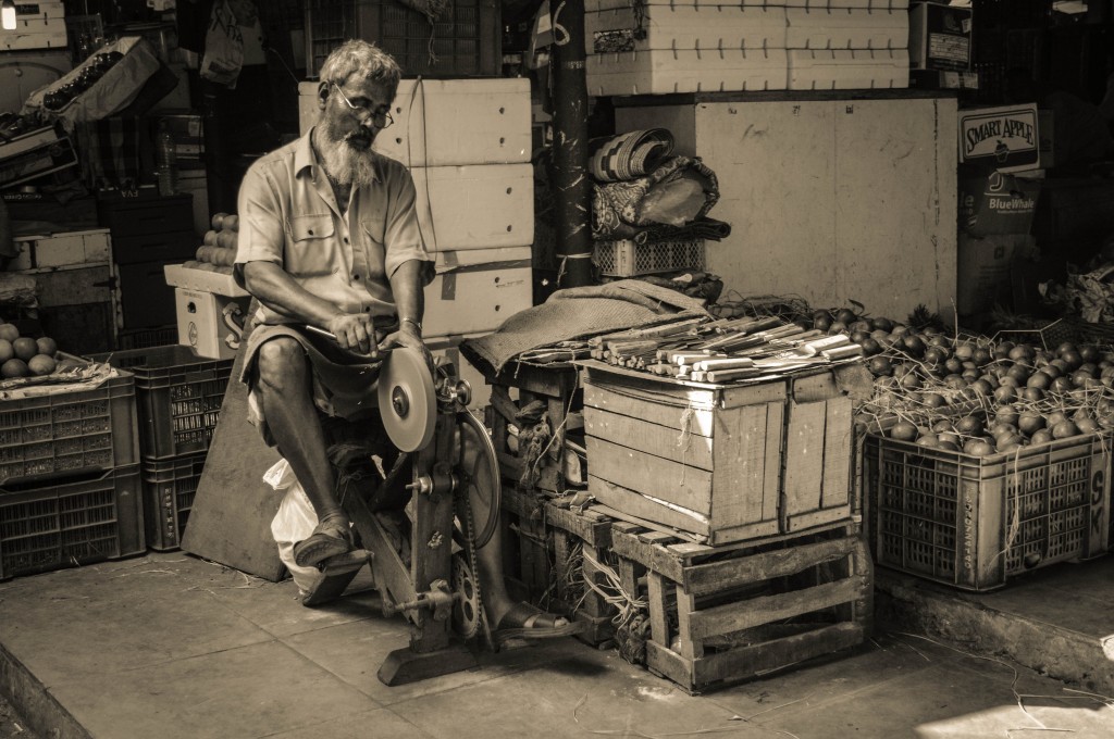 A knife sharpening man at Mumbai Crawford Market