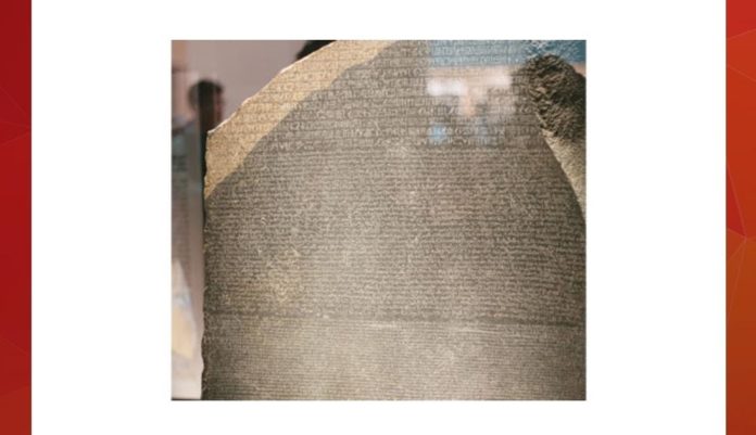 Whose soldiers discovered this famous stone written with three scripts, held in the British Museum?