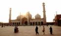 People of various backgrounds walking near the majestic Jama Masjid, highlighting the mosque's beauty and communal atmosphere